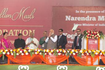 The resplendent Prime Minister walks on stage to a chorus of cheers from audience